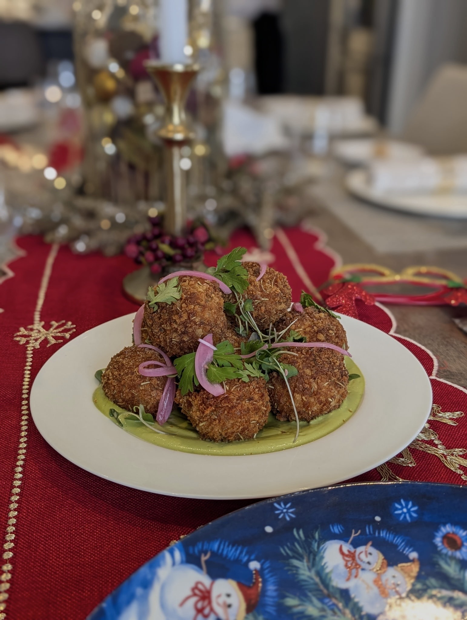 Crispy croquettes with green sauce on holiday table